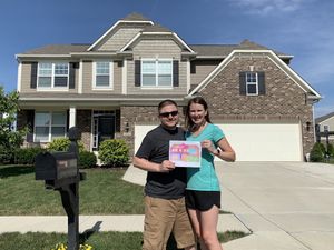 Mrs. Lemon and I in front of our home with our mortgage visualization fully colored in.